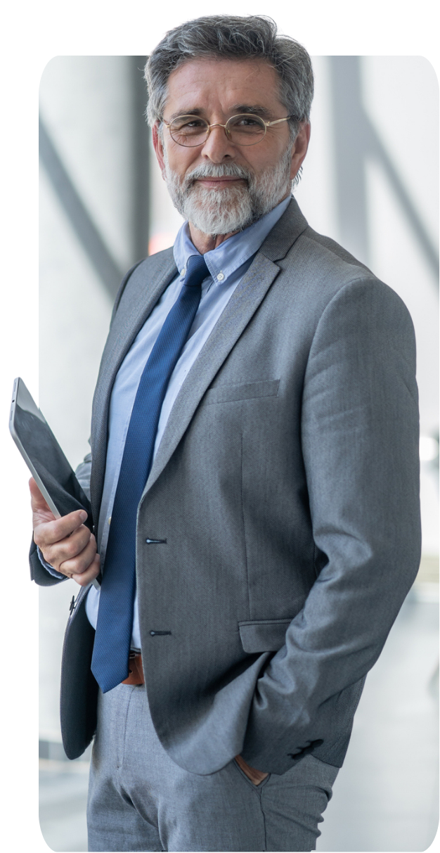 Professional standing with tablet in hand.