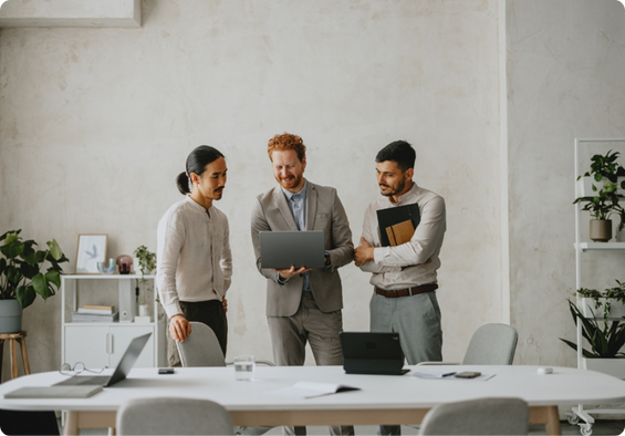 Group of professionals standing together in a workplace setting.