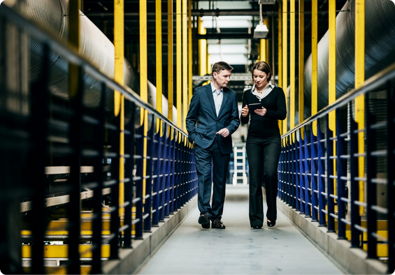 Two colleagues collaborating on a project, looking at laptop screen.