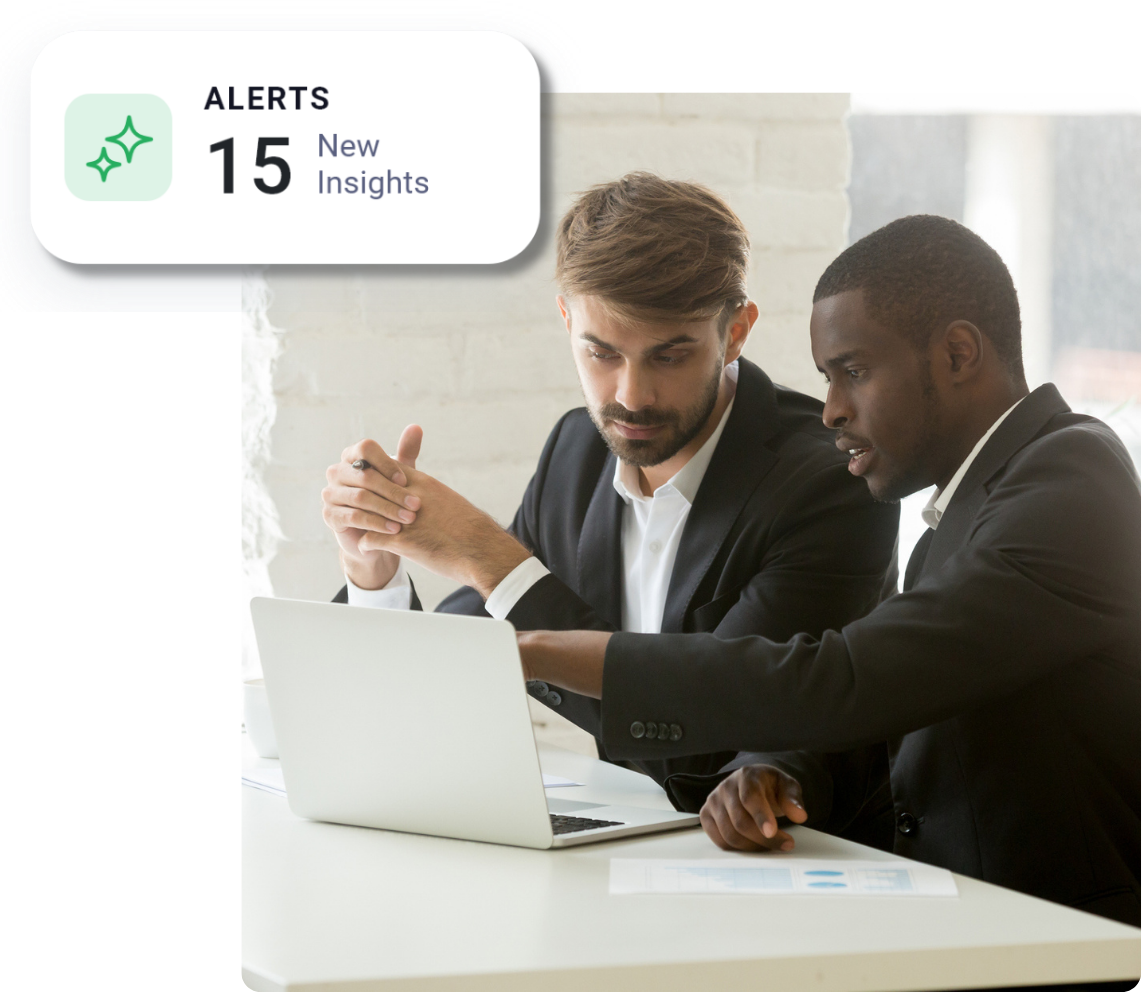 Two colleagues collaborating on a project, looking at laptop screen.