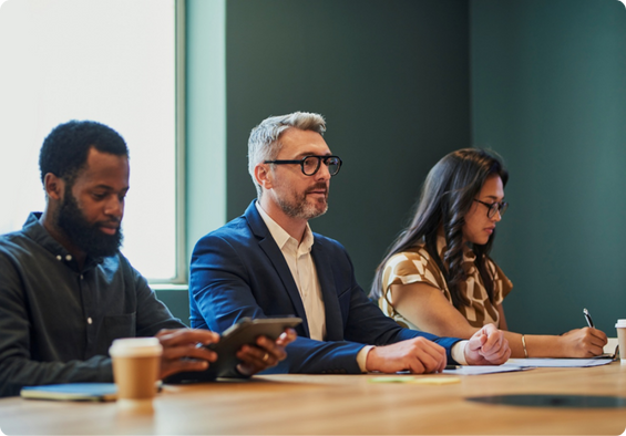 Group of professionals sitting together in a workplace setting.