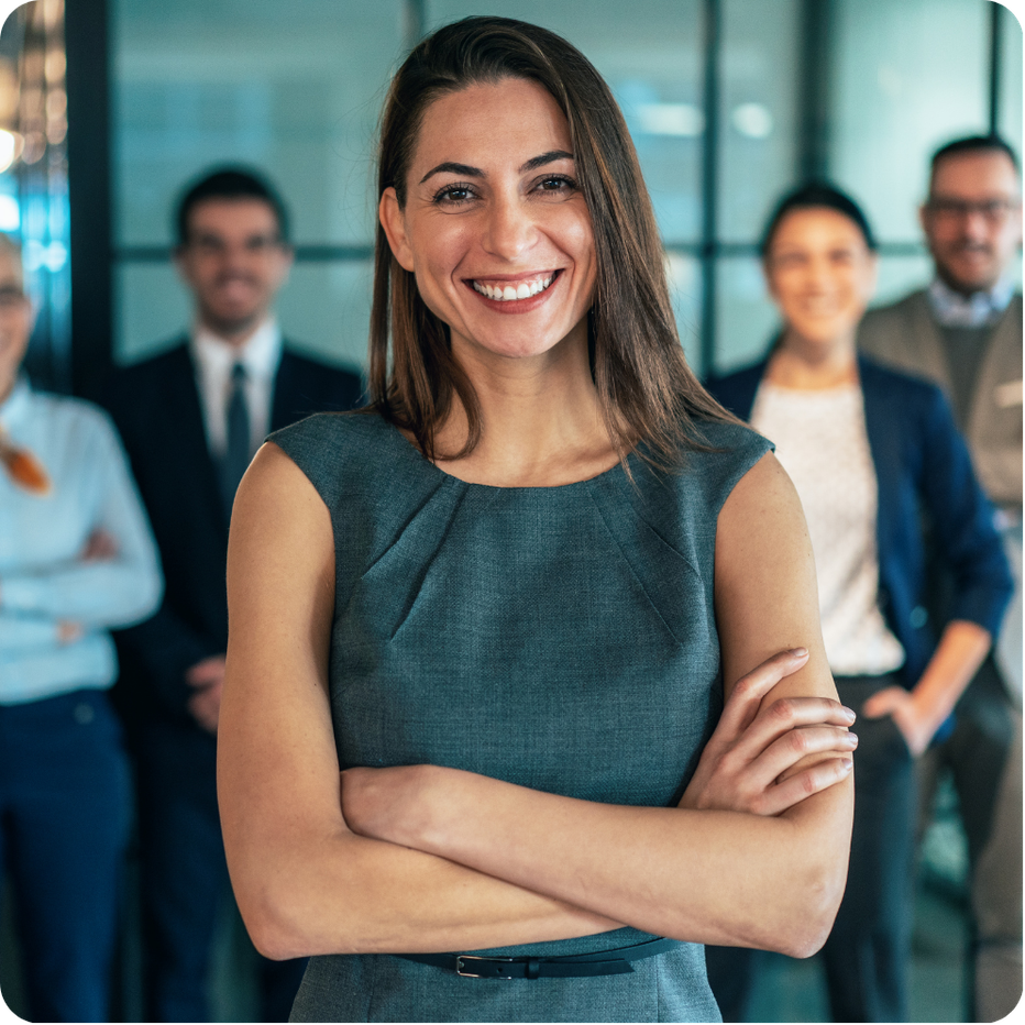 Professional standing in office setting smiling.