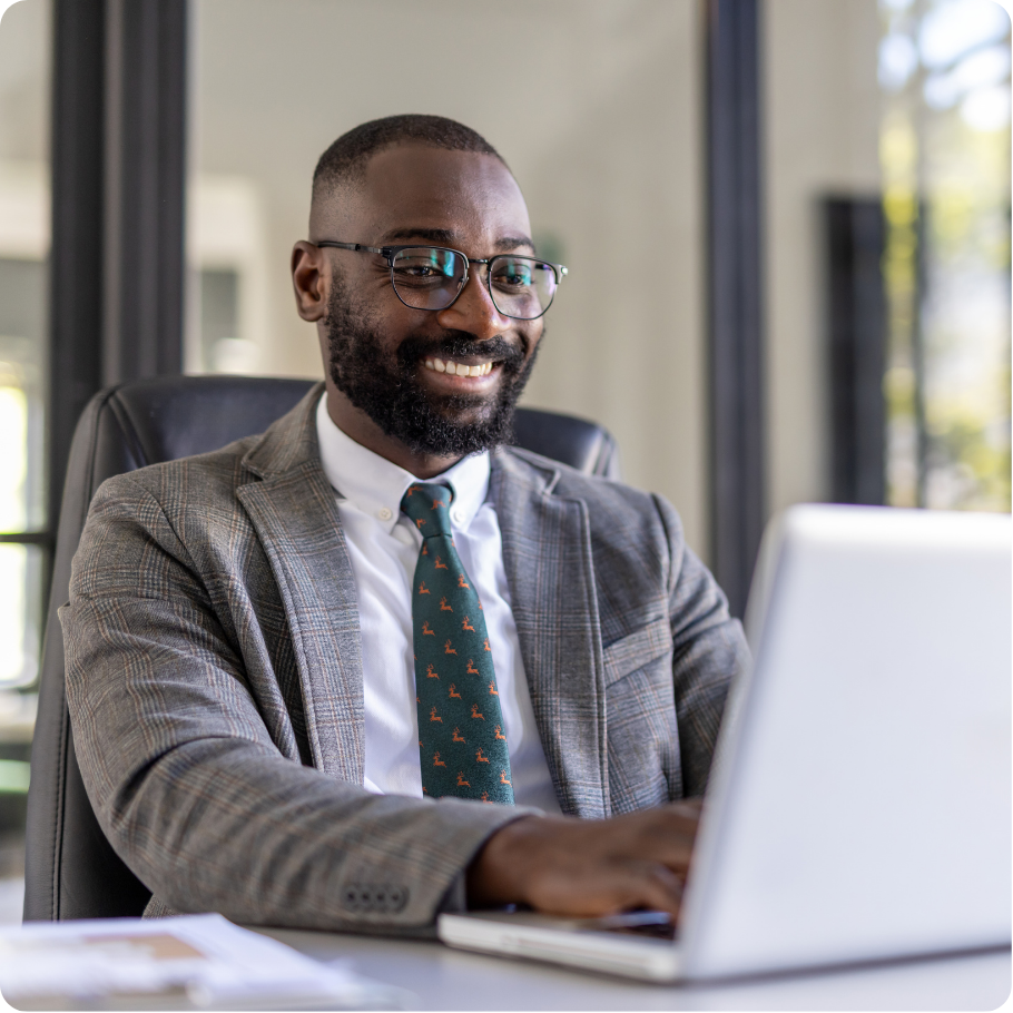 Professional working on a laptop at a desk.