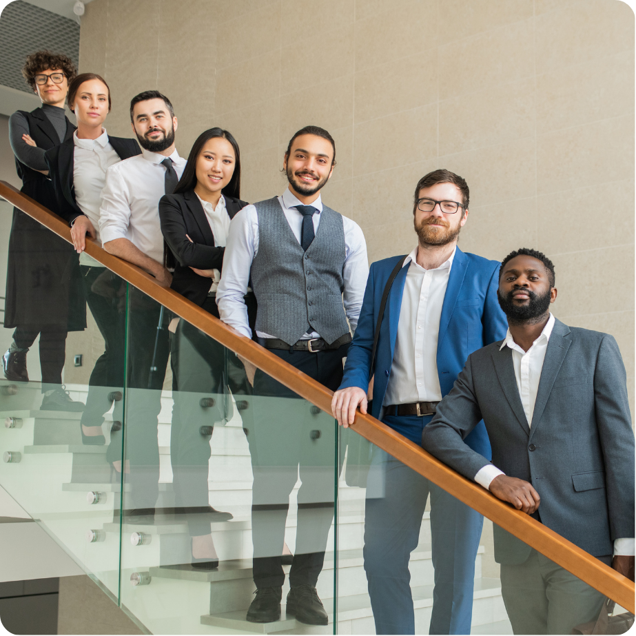 Group of professionals standing together in a workplace setting.
