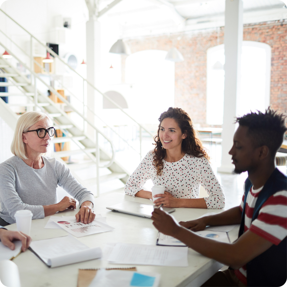 Group of professionals sitting together in a workplace setting.