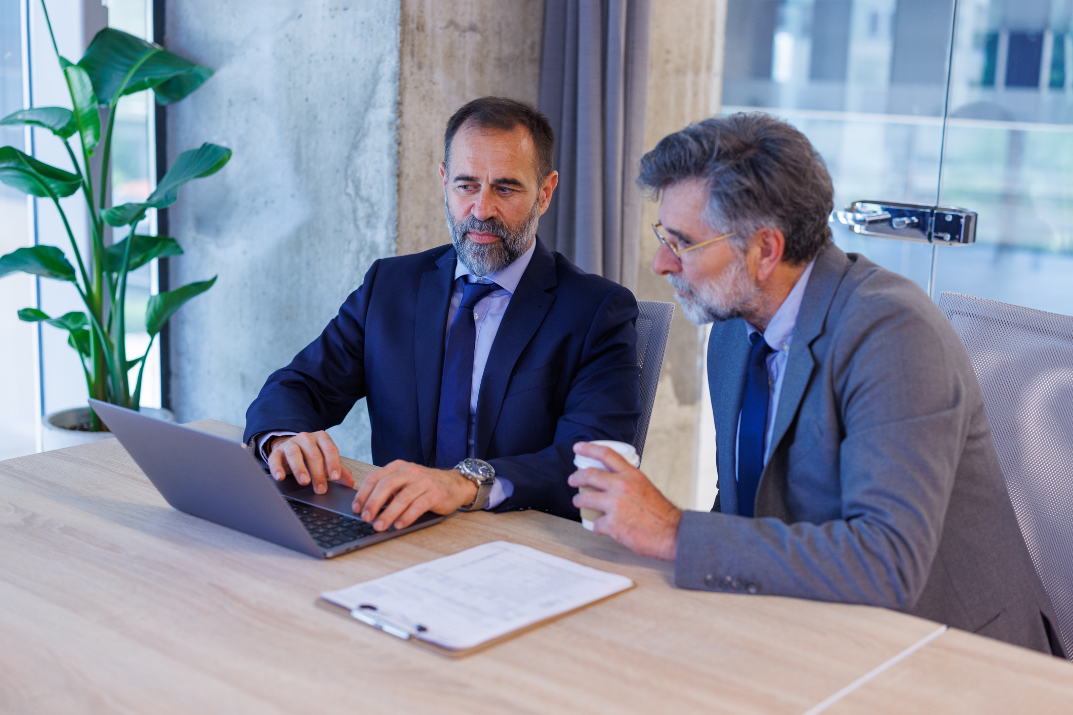 Business leaders reviewing project information together