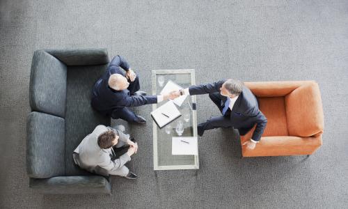 Group of professionals sitting in an office setting.