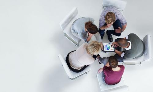 Group of professionals sitting in an office setting.