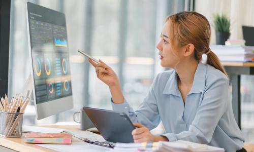 Professional looking at dashboard in office setting.