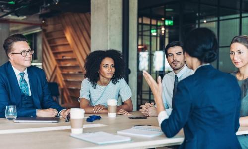 Group of professionals sitting in an office setting.