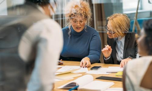 Group of professionals sitting in an office setting.