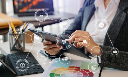 Professional looking at tablet in office setting.