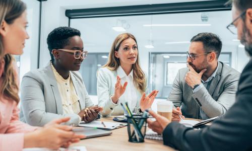 Group of professionals sitting in an office setting.