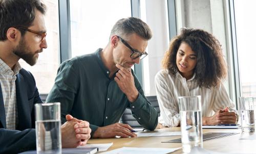 Group of professionals sitting in an office setting.