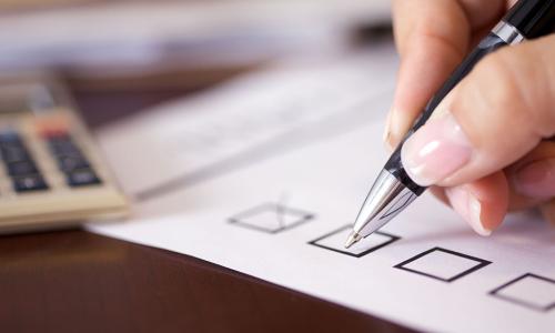 Professional writing on paper in an office setting.