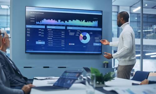 Professional looking at computer monitor in office setting.