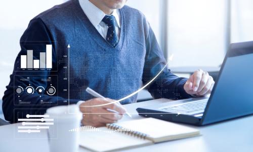 Professional looking at computer monitor in office setting.