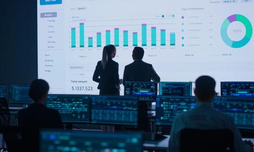 Group of professionals standing in an office setting.