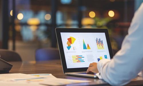 Professional looking at computer monitor in office setting.