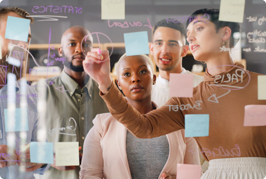 Group of professionals standing in a workplace setting.